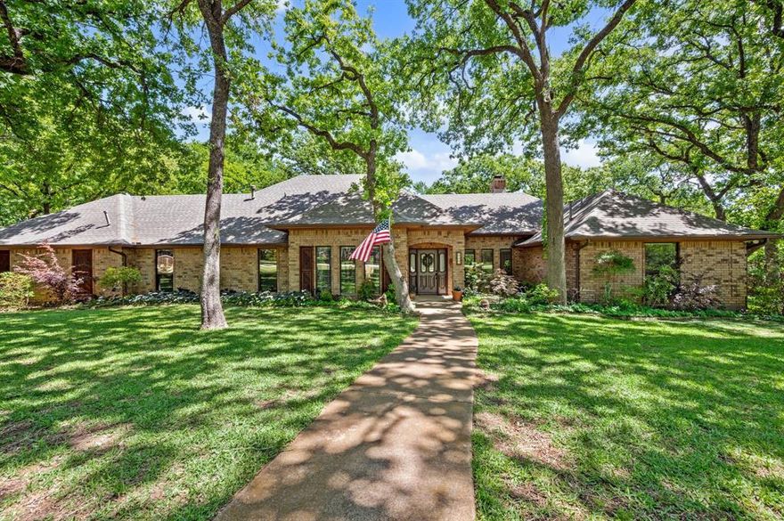 Tucked away on a quiet cul-de-sac street with no HOA, this beautifully maintained one-story home offers the perfect blend of privacy, comfort, and outdoor living on a picturesque one-acre lot in award-winning Carroll ISD. Surrounded by mature trees and backing to Corps of Engineers land, the property features breathtaking views from every window and a peaceful setting enhanced by a small creek running alongside the property.
Designed for entertaining, the home offers 4 spacious bedrooms, 3 full bathrooms, and 2 oversized living areas with flexible space for gatherings and everyday living.  Recent updates include replaced windows, fresh paint, some new carpet, a recently updated pool and decking, and a new hot water heater.  Step outside to enjoy the resort-style backyard oasis with sparkling pool, abundant privacy, and serene natural surroundings.  A detached workshop with electricity provides endless possibilities for hobbies, storage, or workspace needs.  Conveniently located with easy access to major highways, restaurants, shopping, and entertainment, this rare property combines tranquil country-style living with city convenience.