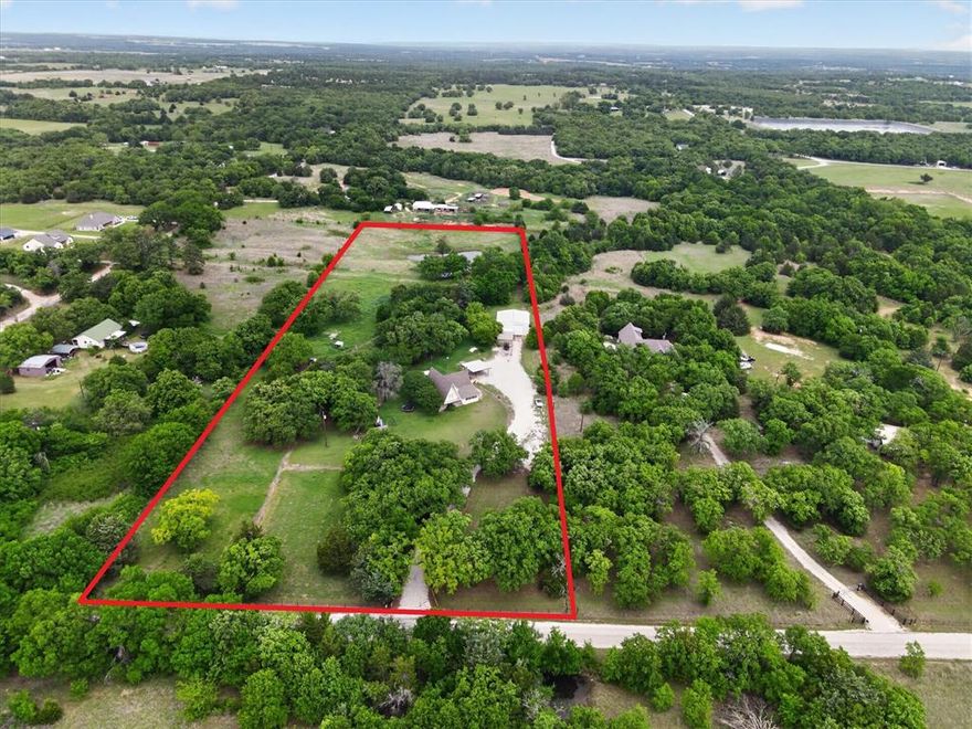 Set on approximately 7.5 acres with agricultural exemption eligibility, this property is not only a dream for outdoor enthusiasts and hobby farmers, but also offers potential tax advantages for those looking to maximize their investment. Featuring an impressive 40x40 metal shop with loft storage, ideal for equipment, hobbies, or a dedicated workspace. Additional improvements include a storm cellar, a greenhouse, and ample space for trailers, boats, RVs, and ATVs. Fenced pastures provide room for animals, gardening, or your homestead vision, while the pond in the back pasture adds both charm and functionality for livestock or peaceful afternoons of fishing. The home offers 2,388 square feet with 3 bedrooms, 2 bathrooms, and a flexible layout. The primary suite is conveniently located downstairs, while upstairs includes two additional bedrooms and a spacious loft that can serve as a game room, office, bunk space, or second living area. Outdoor living is just as inviting, with a large covered back deck and an expansive second-story deck perfect for entertaining or taking in the peaceful country views. Perfectly positioned directly across from the LBJ National Grasslands, it offers immediate access to over 20,000 acres of public land for hiking, fishing, camping, horseback riding, hunting, and exploring. If you’ve been searching for a property that combines usable acreage, quality improvements, and unmatched access to nature, this one is ready to welcome you home.