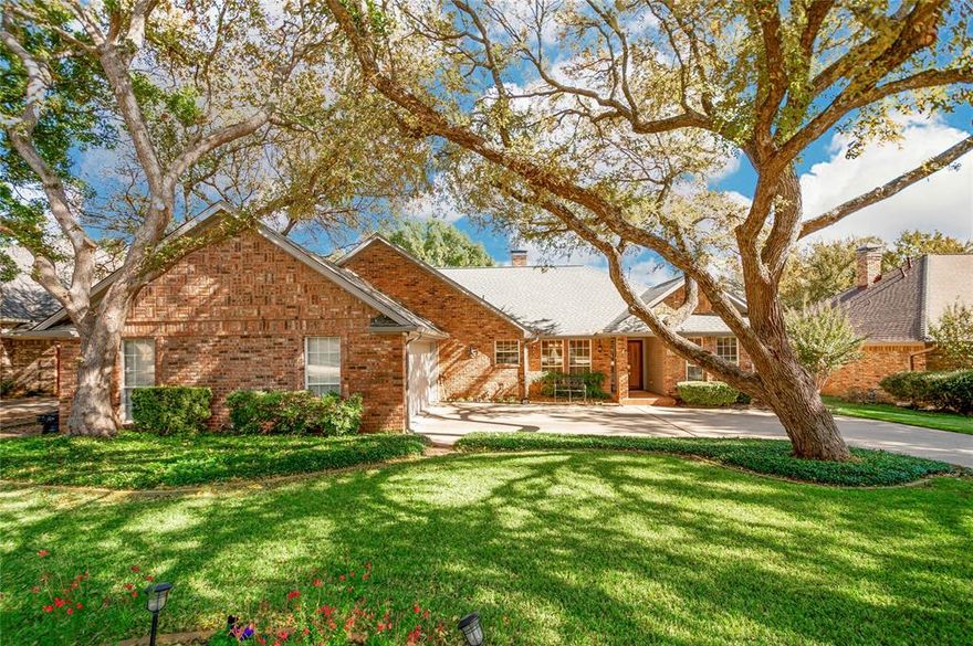 Set on a tree-lined street in the heart of Flower Mound, 1916 Skelton St is the perfect blend of classic beauty and comfortable living. This single-story home features gorgeous wood floors throughout, two living areas connected by a see-through brick fireplace, and multiple dining options ideal for both casual mornings and elegant dinners. The kitchen is beautifully appointed with granite countertops and a view that flows seamlessly into the living space. The primary suite boasts dual walk-in closets, a soaking tub, and separate shower, creating the perfect owner’s retreat. Step outside to discover your own private resort, complete with a sparkling in-ground pool, covered patio, and lush landscaping framed by mature trees. A side patio and yard offers even more possibilities — the perfect spot for a second outdoor living area, garden, or play space.
From its curb appeal to its flowing floor plan, this home captures everything that makes Flower Mound living so desirable.