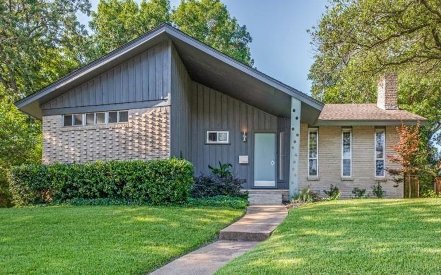 1962 Mid Century Modern.  Original details include slate entry, wood paneling, angled cabinetry, grass cloth wallpaper, exposed wood beams and a sunken living area with gas fireplace. The primary bedroom is irregular in shape, has large closets and an in suite bathroom. Both bathrooms have original 1962 shower tile and mid mod cabinetry that are in great condition.  There is a large 20x19 flex room in the back of the home that could be used as a live in suite.  Large, fenced yard with alley access to carport with 2 covered spaces.  One mile east of the Arboretum, White Rock Lake and Casa Linda Shopping. Owner Agent.