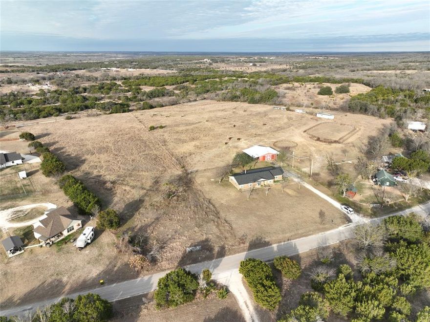 Discover the charm of country living with this delightful 3-bedroom, 2-bathroom ranch-style home nestled on 2 acres in Hico, Texas. Built in 1983, this property is a haven for horse enthusiasts, featuring a well-equipped barn with six stalls, a tack room, horse locker, arena, and vet rack. The inviting living room offers a cozy wood-burning fireplace, perfect for relaxing evenings. Recent upgrades include a brand-new roof, enhancing both durability and curb appeal. The expansive acreage offers ample space for gardening, recreation, or expanding equestrian facilities, all while enjoying the peace and beauty of rural life. Whether you’re an experienced equestrian or simply seeking a serene retreat, this Hico property is ready to welcome you home. We have this property listed with less acreage as well, the options are endless.