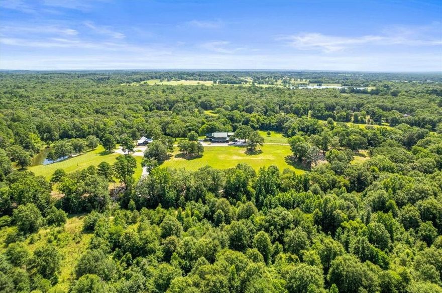 This is more than a property—it’s a lifestyle, business opportunity, and legacy rolled into one. Whether you're drawn to nature, wine, recreation, or simply a slower pace of life, this one-of-a-kind offering in Mineola, TX is ready to welcome its next steward.  The sprawling 58-acres offers unmatched versatility, beauty, and privacy. Nestled directly across from a 3,000-acre nature preserve, the property features a custom main residence thoughtfully designed for both comfort and entertaining with expansive views of the countryside, a separate apartment provides flexible space for guests or caretakers, fully operational winery and mature vineyard totalling approximately 1,550 fully irrigated available vine positions and capable of producing up to an estimated 400 cases per year, perfect for wine enthusiasts or agri-business ventures.  Outdoors, enjoy a stocked fishing pond, abundant wildlife and prime hunting opportunities—making this an ideal sanctuary for outdoor lovers.  Rolling pastures, wooded sections, deep seasonal creek, atv trails and manicured grounds provide a adventurous yet serene and functional setting for both recreation and income-producing potential. Whether you're looking for a personal getaway, business opportunity, or full-time homestead, this one-of-a-kind property offers it all—just minutes from town, yet a world away.  From a business standpoint this could also be a wonderful Wedding venue not just from all the property offers, but also charming Mineola with its rich history, eateries, major retailers and famous Beckham Hotel.  Mineola Nature preserve offers Equestrian trails, 18 hole disc golf, Mountain bike trails & The Birding Capital of East Texas literally at your doorstep!  Truly a one of a kind oppurtunity is used all too often, but in this case fits perfectly!
