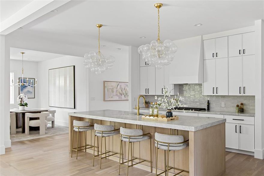 Designed by renowned designer Jessica Koltun and built by Beechwood Custom Homes, this five-bedroom, five-bathroom home offers an exceptional blend of sophistication and livability. The open-concept layout is filled with natural light and thoughtfully designed for seamless everyday living and effortless entertaining.
At the heart of the home is a chef’s kitchen featuring exquisite designer finish-outs, and a prep pantry for additional storage and functionality. The kitchen flows into the expansive living and dining areas, creating a warm, inviting atmosphere.
This open-concept home is filled with natural light, creating an inviting and airy atmosphere. Elegant textures, neutral tones, and high-end finishes flow seamlessly throughout, enhancing its timeless appeal. The expansive dining area is perfect for entertaining, while the bright and spacious living room is anchored by a striking fireplace—offering both warmth and style.
A perfectly curated balance of modern comfort and classic luxury, ideally situated in one of Dallas’ most desirable neighborhoods. Schedule your private tour to experience the craftsmanship and elevated design of a Jessica Koltun home.