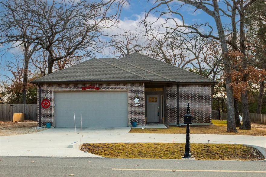 Great opportunity in Lake Kiowa to own this custom built home on a beautiful, treed lot with lots of privacy. Tons of parking with a circle drive, oversized garage, and extra parking for an RV. Featuring 10ft ceilings, vinyl plank flooring, granite counter tops, gas range, and stainless steel appliances. Large primary bedroom has a walk thru closet. Out back is a covered patio, fire pit area with wood racks, and a workshop or storage attached to back of house includes a work bench with access from patio or a garage door. Partially floored attic. Recent updates include drainage lines on north and south side, French drain around circle drive, new wood fencing, replaced drip lines with sprinklers for aerobic septic system, cleared out back of property, primary bath shower glass, built in linen cabinet in primary bedroom, new pull out drawers in kitchen, and built in sundries cabinet in primary closet. Friendly community with a great golf course! Come see what Lake Kiowa life is all about!