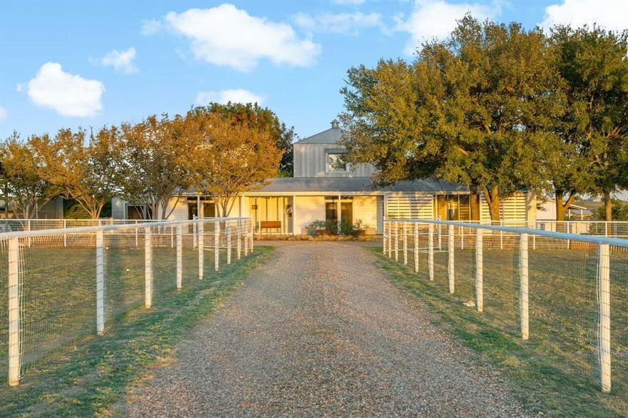 Welcome to 2436 Big Sky Trail - an architectural retreat set beneath wide North Texas skies. Designed by award winning architect Max Levy, this Prairie style home rests on an ag exempt, fully fenced 4.65 ac property and has been featured on HGTV and in multiple design publications. Built in 1999 and spanning 2,113 SF, the 3BD, 3BA residence was thoughtfully composed to complement the surrounding landscape. Pella Architect Series windows and doors frame long views of pasture and sky, creating a seamless connection to the outdoors.  The lower level is designed for gathering, bringing the dining, living, and kitchen areas together in an open layout. Stained concrete floors run throughout the main level. The kitchen features crisp white cabinetry with generous storage, a Viking cooktop, and stainless steel appliances. The fireplace anchors the living area and creates a natural gathering point.  Upstairs, bedrooms are arranged as individual suites, offering privacy while maintaining the home’s architectural character. The screened in porch with its own fireplace extends the living space outdoors and provides a relaxed setting to enjoy the land year round.  Beyond the main residence, the property offers additional flexibility. A 312 SF ADU provides space for guests, a studio, or private office with shiplap walls, full cell insulation, mini split HVAC, and custom door and window detailing. The four stall barn includes a tack room, wash bay, electrical, and lighting. Animal shelters, dog run, garden space, and fire pit enhance the usability of the land.  Ponder offers expansive country living just northwest of Denton while remaining within convenient reach of Dallas and DFW Airport. The adjoining 5.26 ac lot is also available for purchase, offering the opportunity to expand to a combined 9.91 ac, build an additional residence, or preserve greater privacy.