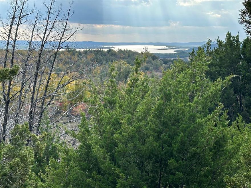 Fantastic lake view!!! One of the highest points in The Hills Above Possum Kingdom, this lot has a phenomenal view of the north end of Possum Kingdom Lake. This lot should be pretty easy to put in a driveway and not too tough to build on. Multiple best sites for building on, you choose.  In a culdesac at the end of a long street, the lot is secluded and very private. The terrain falls away from the street level and maximizes the panoramic view. Lot ownership permits the use of all of the neighborhood amenities, including; boat storage, community clubhouse with pool and fitness center, cabin and picnic grounds, community dock, boat ramp, fishing pond, and twenty miles of private roads behind the gates.