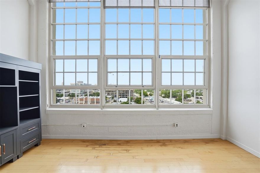 Make this condo your own! Montgomery Plaza #1727 is an exceptional 2 bedroom, 2 bathroom residence that offers the ultimate lock-and-leave lifestyle in one of Fort Worth’s most iconic buildings in the most walkable neighborhood. Located on the 7th floor, this condo showcases breathtaking, unobstructed views of the Cultural District through dramatic 16-foot floor-to-ceiling windows that flood the space with natural light.

Originally a historic landmark, Montgomery Plaza was thoughtfully transformed into luxury condominiums featuring resort-style amenities, premier retail, dining, and everyday conveniences all within the building and surrounding pockets on W7th. Residents enjoy a vibrant urban lifestyle just minutes from Downtown Fort Worth, Sundance Square, The Stockyards, the Museum District and Near Southside.

Inside, sophisticated finishes create a timeless yet contemporary aesthetic. Engineered hardwood flooring, museum-smooth walls, transom windows, dark-stained cabinetry, and industrial-inspired architectural details complement the soaring ceilings and expansive open-concept design.

Beyond the residence itself, residents have access to an impressive collection of amenities including a resort-style pool with private cabanas, outdoor cooking and entertaining areas, a fully equipped fitness center, movie theater, and an inviting third-floor owner’s lounge designed for gathering and relaxation.

The property also includes two side-by-side DEEDED parking spaces in the attached garage. Pricing has been adjusted to reflect the estimated repair of the living room wood flooring, presenting an outstanding opportunity to own in one of Fort Worth’s most desirable urban communities. Seller is providing a $10,000 flooring allowance.