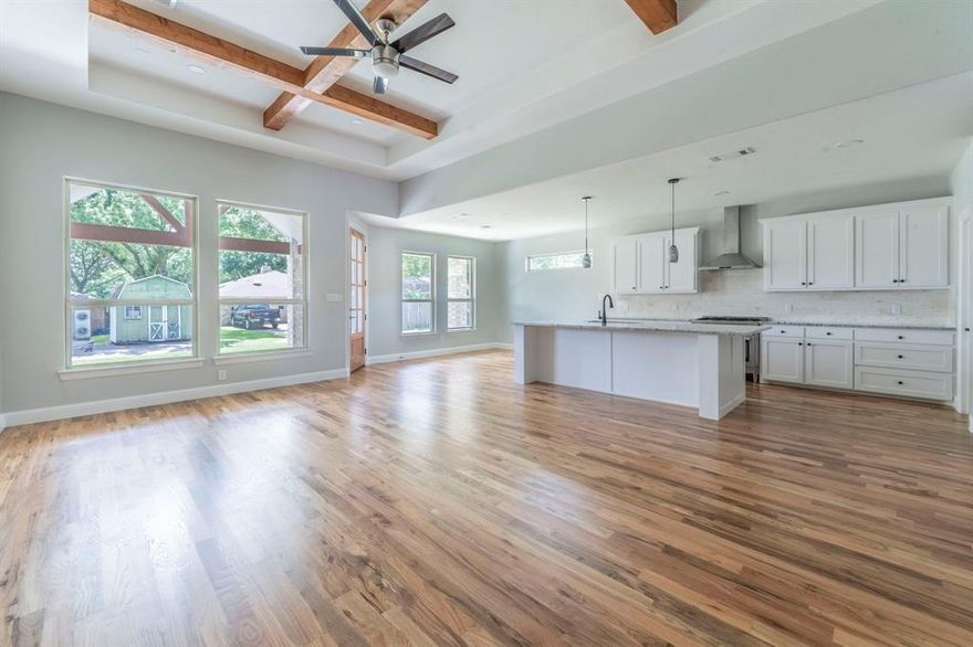 OPEN HOUSE SATURDAY Dec.6 from 11am - 1pm. Beautiful 4-Bedroom New Construction in Established Neighborhood. This stunning new home offers 4 spacious bedrooms, 2 full baths, a half bath, and a dedicated office ideal for today's lifestyle. Featuring wood flooring throughout and an open-concept layout, this home is perfect for both everyday living and entertaining. The living area boasts soaring 12' ceilings with decorative beams, adding elegance and warmth. Step outside to a vaulted, covered rear patio—perfect for relaxing or hosting guests. An oversized driveway provides ample parking. Located in a well-established neighborhood, this home blends modern comfort with timeless charm.