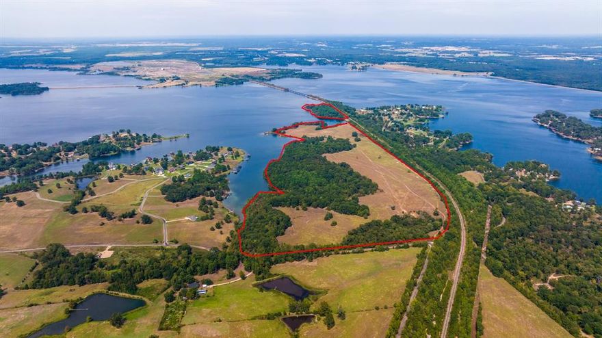 Approx 150 waterfront acres that might be the last undeveloped acreage on Lake Bob Sandlin!! Perfect for the subdivision of your dreams! Gorgeous level pastures, beautiful open water and plenty of mature trees.  Waterfront on one side, backing up to a dormant railroad track on the other.  Close to Barefoot Bay Marina on the southern side of the lake across the cove from gated Eagle Shores.