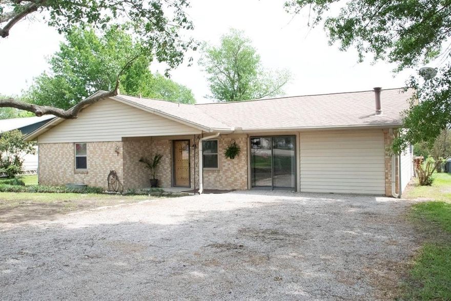 Brick home with top-grade aluminum siding located outside city limits and conveniently near major Limestone County employers, including the Mexia State Supported Living Center.  This home offers 3 bedrooms, but has been used recently as a two-bedroom, with the primary bedroom opened to the adjacent room - ideal for a larger suite, office, nursery or even dressing room space!  Both rooms include closets, and the primary bath features an updated tile shower.  

Recent improvements include new triple-pane windows and kitchen appliances.  A converted garage provides a comfortable family room with a wood-burning stove, opening to an additional living or dining room.  

The kitchen includes a breakfast area overlooking a fenced backyard with mature greenery and a greenhouse with electricity, offering great potential for gardening.  Priced at $183,500, this home is a solid option for a first-time buyer or someone looking for a short commute.
