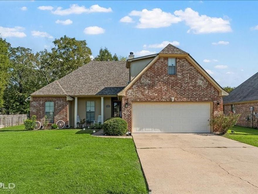 Charming 3-bedroom, 2-bath home in desirable Palmetto Park subdivision in Benton, just minutes from Cypress Black Bayou and nearby boat launch. This well-maintained home features an open-concept layout with an oversized living area, cozy fireplace, and large windows for natural light. The kitchen offers abundant cabinet space, a breakfast bar, and a dining area. The spacious primary suite includes wood flooring, two walk-in closets (one oversized), and a private bath with separate tub and shower. Bonus room above the garage can serve as a 4th bedroom, office, or flex space. Wood and tile flooring in main areas, carpet in secondary bedrooms. Enjoy a large fenced backyard with a covered patio perfect for entertaining. Roof replaced in 2020, water heater 2023. Two-car attached garage. Located in the sought-after Benton school district and close to parks, shopping, and more. Move-in ready and priced to sell!