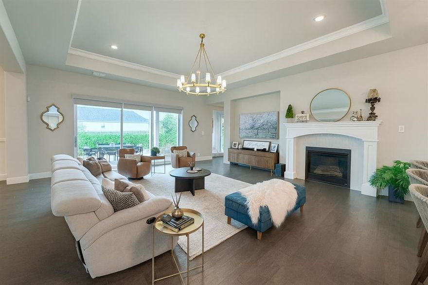 In a neighborhood where homes can blend together, this Drees-built beauty stands out from the rest and is LIKE NO OTHER! Perched on a scenic corner lot at the top of a hill, this one-story home blends modern luxury with thoughtful functionality. From the moment you step inside, you'll notice the designer finishes and intentional details that make this home one-of-a-kind.

The expansive open-concept living area features a cozy fireplace and flows seamlessly into the formal dining room and immaculate kitchen. Culinary enthusiasts will love the oversized island, custom lighting, and an impressive butler’s pantry for extra prep and storage space. A sleek bar area with wine fridge adds the perfect touch for entertaining.

Need to work from home or stay organized? A built-in pocket office and spacious mudroom with storage provide smart solutions without sacrificing style. There’s also a bonus secondary living space—perfect as a game room, media space, or playroom.

One of the home’s standout features is the wall of fully retractable glass pocket doors that open completely, extending the living space to a large covered patio with firepit—bringing the outdoors in for year-round enjoyment.

Just steps away from Walsh Market and the award-winning community amenities: resort-style pools, fitness center, lake, miles of hike and bike trails, tennis and basketball courts, playgrounds, and parks galore. HOA includes full access to amenities, front lawn maintenance, high-speed internet, and white glove trash service.

This is not just another house—it’s a rare find in Walsh that delivers luxury, convenience, and individuality in one perfect package.