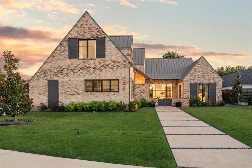 Some homes just feel different the moment you step inside, where every detail is intentional. Built in 2023 and set in the heart of Southlake, this home pairs architectural precision with warmth and livability. The kitchen is a centerpiece, blending function and design with a waterfall-edge marble island, custom cabinetry, and an oversized pantry.The open-concept living areas are defined by vaulted ceilings with wood beams and walls of windows that fill the home with natural light and create a seamless connection to the outdoors. The covered patio extends the living space with an outdoor kitchen, fireplace, and seating areas overlooking a pool and spa surrounded by turf for easy maintenance and year-round fun.Inside, a dedicated entertainment room with expansive windows offers a bright, inviting space for movie nights or casual gatherings. The moody downstairs office adds a touch of sophistication with built-ins and rich finishes that make it as functional as it is beautiful. 
The primary suite is tucked away for privacy and features views of the backyard, while a first-floor guest suite provides convenience for visitors.
Upstairs, three ensuite bedrooms are complemented by an additional TV or lounge area, offering flexibility for families or guests. Throughout the home, layered textures, exposed bricks, neutral tones, and thoughtful details create a cohesive and calming atmosphere.Located in Southlake with open enrollment to Carroll ISD, this home blends modern design, comfort, and location into something truly special.