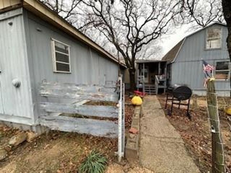 Price Improvement! Affordable property near Eagle Mountain Lake featuring a main home that can be configured as a two or three-bedroom space by utilizing the loft. The main home is a mobile home with additions. Cash or creative financing likely required for the purchase. The property, generously sized, is mostly fenced with trees, offering a serene setting with multiple porches and patios. Additionally, there is a guest home with one bedroom, a full bath, and a kitchen. The property includes two storage buildings, a workshop with an attached chicken coop, and a long private drive. Ideal for investors, this fixer-upper requires TLC to bring out its full potential. Home is currently being emptied and cleaned. Pictures were taken before clean up started, excuse the mess as it is an estate and investment opportunity. Mineral Rights convey!