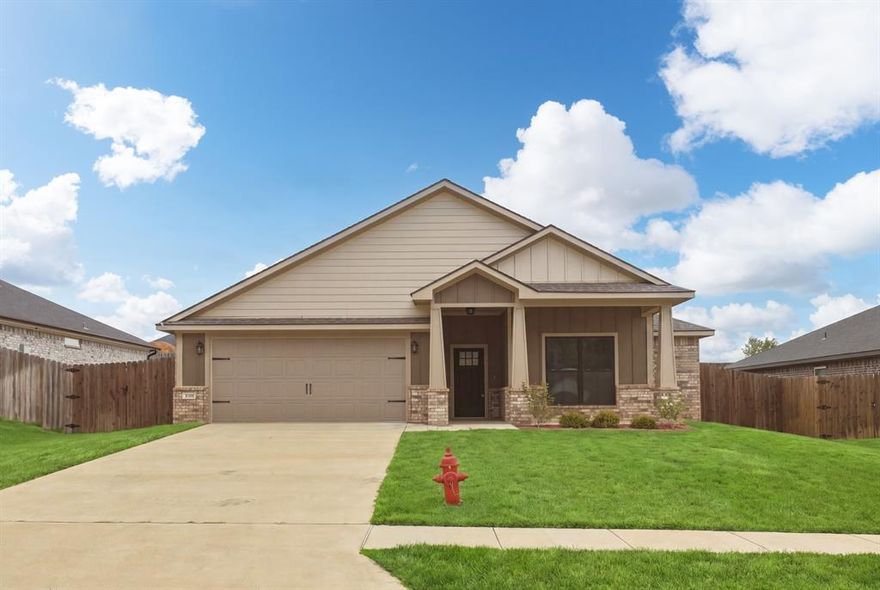 Be part of one of Lindale’s newest neighborhoods in this thoughtfully designed 3-bedroom, 2-bath home offering approximately 1,700 sq. ft., conveniently located near Lindale High School. Move-in ready, this residence features an open-concept layout with a split-bedroom floor plan that enhances both privacy and functionality.

The kitchen serves as the heart of the home, showcasing granite countertops, an island with breakfast bar seating, and seamless flow into the dining area and spacious living room with oversized windows that bring in abundant natural light.

The primary suite offers a well-proportioned retreat with a generous walk-in closet and an en-suite bath complete with a double vanity and a soaking tub shower combination. Two additional bedrooms, each with walk-in closets, share a well-appointed hall bath and are ideally positioned near the utility room for everyday convenience.

Smart home features, including a Nest thermostat and LiftMaster garage system, provide modern control and ease of living directly from your phone or tablet. The fenced, sodded backyard extends the living space outdoors, offering a functional area for recreation or relaxation.

With its combination of modern features, practical layout, and established neighborhood setting, this home offers strong long-term livability in a growing Lindale area.