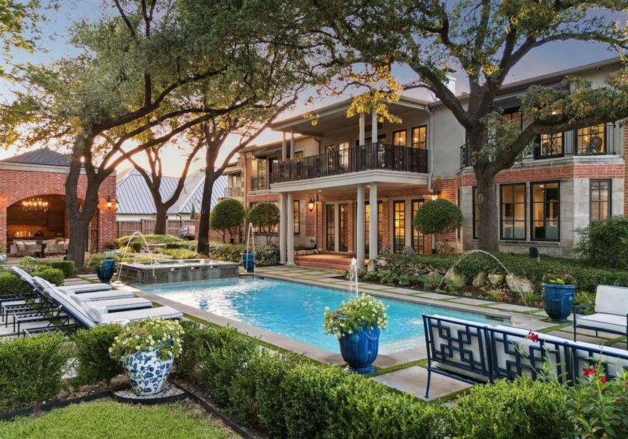 An exceptional offering and value in the heart of Old Preston Hollow’s estate area—priced BELOW appraised value and set on over 1 acre of resort style grounds. The expansive 9,953 sq ft main residence offers 6 bedrooms, 8 baths + an additional 1,250 sq ft 2024 guest house w 2 ensuite bedrooms, full kitchen, living-dining areas, covered terrace + walk-in laundry. Newly reimagined, guests are welcomed through a soaring 24 ft foyer anchored by grand dual staircases w floor to ceiling windows and well appointed living-dining rooms w matching 20ft FPs. Designed for grand-scale entertaining, the home features 3 tandem living areas, including a central salon w imported antique stone FP and Italian stone columns, walk-in bar finished in black marble that flows into the relaxing lounge + charming 25 ft keeping room off of the kitchen. The European kitchen is a showpiece: marble countertops + backsplash, dual sinks + dishwashers, pot filler, lighted display cabinetry- w a lighted silver display closet and a large working pantry w 2nd side x side fridge-freezer + abundant storage. A large media room, 2 oversized marble powder baths, fitness room, which can double as an additional bedroom. The exceptional primary retreat is complete w marble spa bath, heated floors, steam shower, standalone tub, an expansive custom closet + 2 balcony terraces viewing back yard. A separate in-law suite mirrors the primary layout. Outdoors, the estate unfolds with multiple covered terraces, pool and spa, jetted water features, hardscape terrace along w space for sport court or putting green. The adjacent cabana is fully equipped with 2nd kitchen w 2 dishwashers, green egg, floor-to-ceiling stone fireplace, remote screened living + dining areas, ceiling heaters - perfectly suited for seamless year round indoor-outdoor living. Additional features include five-car motor court, extra parking, 2023 roof. A rare opportunity and value to own in the distinguished neighborhood and private school corridor.