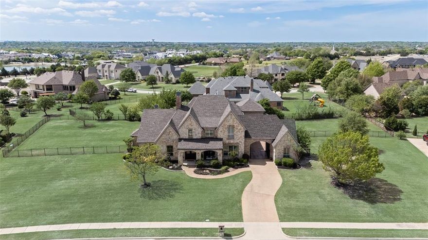 Welcome to this immaculate 4,737 SF home in the highly sought-after Cobblestone Farms community in Heath where timeless design meets luxury and comfort. Situated on a full acre, this property offers a private retreat with a spacious backyard and multiple outdoor living areas, including a second-story balcony. Inside, the home truly feels like it’s straight out of a magazine, showcasing thoughtful designer touches at every turn. From custom wallpaper and hand-scraped hardwood floors to plantation shutters, decorative lighting, and extensive built-ins, every detail has been carefully curated. Just off the main entry is the study with vaulted ceiling accented with wood beams and French doors for added privacy. The dining room offers natural light with pass through butler's pantry to the expansive kitchen designed for gathering. It features a large island with prep sink, custom cabinetry, double ovens, dual dishwashers, and a walk-in pantry. The adjacent breakfast room adds both convenience and elegance. Upstairs, you’ll find an oversized game room complete with built-in cabinetry, dual desks, and a wet bar, along with a dedicated media room accessed through theater doors with a projector and screen and pull up eating bar. Two additional bedrooms, each with walk-in closets, share a spacious hall bath. The primary suite is a true retreat, offering an ensuite bath with jetted garden tub, walk thru shower, separate vanities, and dual walk-in closets. The main level also includes a private guest suite with its own entrance and full bath—ideal for in-laws or long-term guests. Oversized garages will accommodate four larger vehicles. A gated courtyard provides additional secure parking and enhances the home’s impressive curb appeal. Outdoors, the covered living area features a beautiful fireplace and overlooks the backyard, offering plenty of room to play and add a pool. This exceptional property blends luxury, functionality, and space in one of Heath’s premiere neighborhoods.