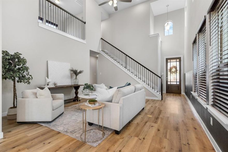 **INQUIRE ABOUT OUR 2-1 RATE BUY DOWN** Welcome home! Nestled in the highly sought-after Pecan Square community, this charming two-story residence offers comfort and style at every turn. Step inside to a warm and inviting living room with soaring ceilings that fill the space with natural light. The kitchen is a true centerpiece, featuring built-in cabinetry, a generous island with a convenient breakfast bar, and plenty of room for entertaining. Even better, the refrigerator stays, adding convenience from day one. A quiet home office with its own walk-in closet provides the perfect retreat for work or study. The serene primary suite is designed for relaxation, showcasing cool tones and soft natural light. Its luxurious ensuite bathroom boasts dual vanities, abundant storage, and a spacious walk-in shower. Upstairs, enjoy a versatile loft area ideal for a second family room, game room, or creative space, along with three additional bedrooms for loved ones or guests. The spacious layout is perfect for relaxing around the included 86 inch TV, creating a true gathering hub for memorable occasions. Outside, the low-maintenance backyard is ready for effortless entertaining. To make moving in even easier, the washer, dryer, additional freezer, and cordless Dyson vacuum will also remain with the home. This Pecan Square gem seamlessly blends comfort, functionality, and style, schedule your showing today!