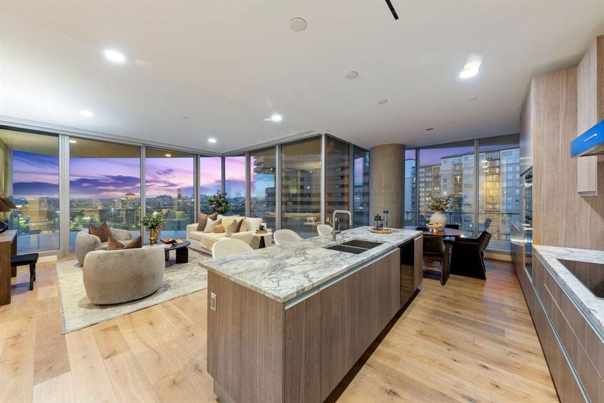 Elevated luxury meets modern sophistication in this meticulously designed three-bedroom, three-bathroom condominium. Flooded with natural light, the residence showcases impeccable craftsmanship, including rich hardwood flooring throughout all bedrooms, bespoke California Closets, and contemporary designer wallpaper that adds a touch of refinement. The gourmet kitchen is a chef’s dream, featuring sleek granite countertops, a choice between a Miele gas or electric cooktop, a built-in wine storage refrigerator, and a high-end dishwasher for effortless entertaining. The spa-inspired main bathroom offers frosted glass for privacy, while all bedrooms are outfitted with custom blackout blinds to ensure restful nights. For optimal comfort and security, the home is equipped with an Ecobee smart climate control system and an advanced leak detection system. Expanding the living experience outdoors, the impressive 825 sq. ft. wraparound terrace provides breathtaking panoramic views of both Downtown and Uptown. Thoughtfully designed for relaxation and entertainment, it boasts ample space for al fresco lounging and dining, complete with a mounted television for an enhanced outdoor experience. 

Residents of Bleu Ciel enjoy world-class amenities, including a designer spa with a resort-style pool, jacuzzi, sauna, steam room, and private massage room.  The state-of-the-art gym features a yoga studio and direct Katy Trail access. For social and professional gatherings, the property offers a business center, private event spaces, a community lounge, and a wine tasting room. Additional conveniences include a private two-car garage within a secured master garage and 24-7 valet service, ensuring effortless luxury and comfort.