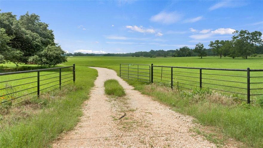 Rare opportunity to own gorgeous large parcel of land just 1.5 miles from town and near high school. Land has been significantly cleared and boasts beautiful coastal grass. Property is bordered by FM 16 and CR 4100 and is entirely fenced. There is approximately 1375 ft of frontage on FM 16 side and approximately 1900 ft of frontage on CR 4100 with entrances from both roads. Wonderful opportunity for development or farm and ranch property. Large barn and working cattle pens in the middle of the property. Live spring fed creek flowing through back portion of property. City of Lindale annexed property across the street and approved for city sewer so any potential development could connect to city sewer. Property can be purchased in 2 separate parcels as well. See MLS 23008191 and 23008195 for divided property listings.
