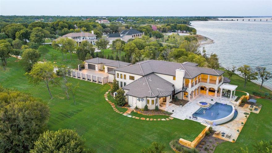 No expense was spared on this breath taking, one of a kind, water front property in Sunrise Bay on Lake Lewisville. Nestled deep on a unique peninsula lot with extraordinary 180 degree panoramic views of the the lake this Mediterranean style property is unrivaled. Built with insulated concrete form (ICFs) walls with a lime stone exterior the home is energy efficient and has superior structural safety & integrity. The custom property boasts a number of luxury features including temperature controlled wine room, elevator, heated & air conditioned outdoor living, built in Miele coffee machine, 2 steam showers, Andersen windows & more. State of the art Savant smart home system & matrix that distributes, audio and video throughout the house by individual room. Stunning view of the lake from the expansive outdoor living with 2 story loggia, full outdoor kitchen, fireplaces & outdoor staircase, can be completely enclosed with electric shades. You have to see it to believe it!
