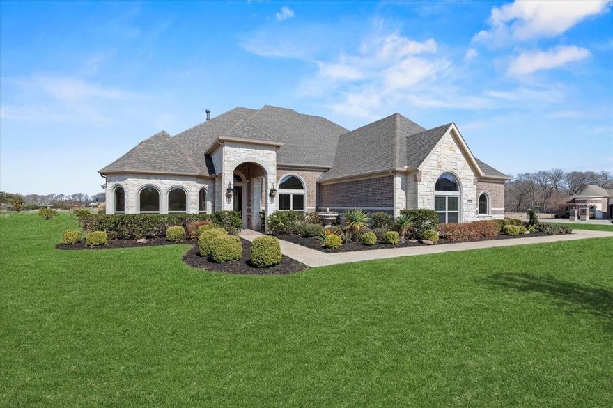 Experience luxury living in this breathtaking single-story home, gracefully situated on a corner one-acre lot in Lucas. Spanning over 3,600 square feet, the elegant foyer with extensive hardwood floors welcomes guests into this exceptional entertainer’s home, thoughtfully designed with both style and functionality in mind. A private home office is positioned at the front of the home and features a wall of arched windows that flood the space with natural light, along with a convenient closet for added storage. Host memorable dinner parties in the formal dining room, which flows effortlessly into the kitchen for seamless entertaining. The warm and inviting living room showcases a floor-to-ceiling stone gas fireplace and offers uninterrupted sightlines into the kitchen and breakfast area. The gourmet kitchen is sure to impress, featuring granite countertops, an Electrolux five-burner gas cooktop, dual ovens, and under-cabinet lighting. The secluded primary suite is tucked away at the back of the home, offering ample privacy. The luxurious ensuite bath serves as a true retreat, complete with dual granite-topped vanities, a spacious glass-enclosed shower, and an expansive 16x11 walk-in closet. Additional features include a three-car garage with durable epoxy flooring, providing both style and functionality for your vehicles and storage needs. Step outside and unwind in your backyard oasis, featuring both a covered patio and an open patio plumbed for a future hot tub. With abundant space to design your dream pool, garden, or outdoor living area, this property offers endless possibilities.