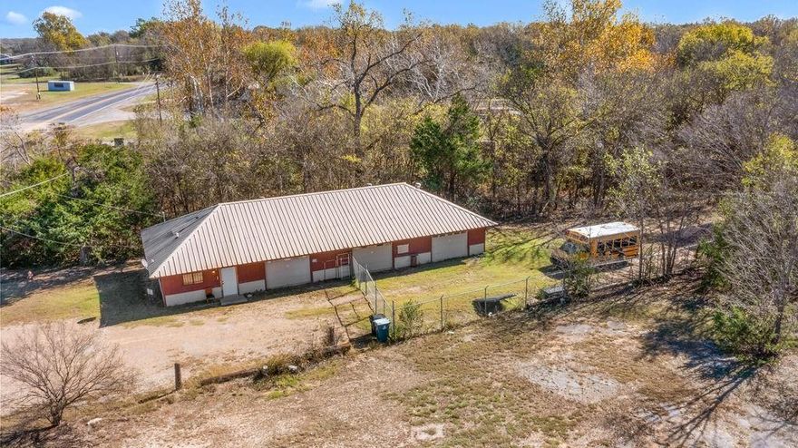 This versatile commercial property sits on a 0.6-acre lot with excellent visibility along Hwy 69 and features three 20x30 bays with 10x7 manual sectional roll-up doors, a remodeled 15x30 office with its own bathroom, and plumbing in the third bay, offering outstanding flexibility for a wide range of business uses. A 1,000-gallon septic system with approximately 400 ft. of lateral lines was installed within the last five years, enhancing the updated infrastructure. Outside, a fenced-in area provides secure parking for vehicles, equipment, or trailers. With strong exposure, ample space, and multiple functional features, this property is ideal for contractors, mechanics, fabrication, small manufacturing, or anyone seeking a commercial space with endless possibilities.