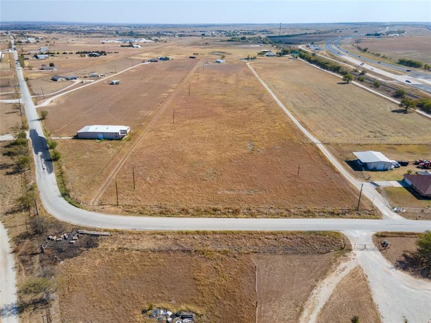 READY FOR DEVELOPMENT-AIRSTRIP ACCESS-HANGAR ON SITE-BRING YOUR BUSINESS! Just a few feet from the Hwy 287 corridor between Rhome & Decatur. 45 minutes from DFW. 30 minutes from Alliance, 10 minutes from the shopping & amenities of Decatur. Directly adjacent to Rhome Meadows Airport & grass runway. Property features 333 feet of paved, county road frontage on County Road 4421 with gated access. 16.42 acres as a whole or can be split into 10 & 6.42. Check out the sub-listings coming soon.  Zoned Manufacturing by the city of New Fairview. Tons of potential for a multitude of manufacturing & industrial uses, including RV park, mini-warehouse & storage, assembly plant, storage yard, machine shop, manufacturing facility, Oil & gas drilling, production or infrastructure, salvage or truck yard, trucking company...the possibilities are endless! 40x40 hanger with slab foundation & several concrete buildings already on site. Ag exempt with water & electric to the property. Even some vintage planes that are for sale at the right price. Verify desired usage with the City of New Fairview. All information herein is subject to verification by purchaser. Fantastic location with easy access. Don't let this one get away if you're looking to expand your business endeavors in this growing, rural area. Survey available.