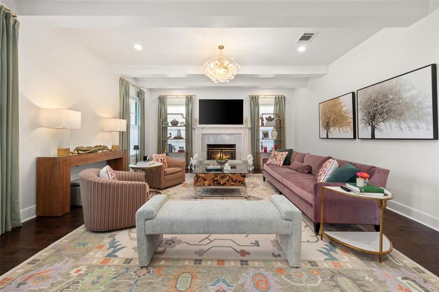 Conveniently located within walking distance of River Crest Country Club, this beautifully designed home features 5 bedrooms and 3.5 bathrooms, offering a layout ideal for both everyday living and entertaining. The downstairs primary suite includes a sitting area, fireplace, and en-suite bath with dual vanities, a soaking tub, separate shower, and generous walk-in closets with built-ins. Throughout the home, you'll find stunning hardwood floors, soaring ceilings with rustic wood beam accents, and decorative lighting. The spacious kitchen is complete with a large island, gas cooktop, farmhouse sink, custom cabinetry, and granite countertops. Upstairs, a large game room or den is accompanied by three additional bedrooms and two full baths, providing plenty of space for family or guests. Charming patio perfect for entertaining, featuring a built-in grill, sink, and outdoor fireplace. The property also includes a detached two-car garage and a front parking pad for additional convenience.