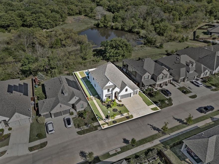 Welcome to a truly exceptional home where luxury, tranquility, and outdoor living come together seamlessly. Situated on a premium lot, this property backs up to a greenbelt with serene views of a pond and mature trees. Inside you will find a light-filled, open-concept layout with soaring ceilings, expansive windows, and high-end finishes throughout. The kitchen is designed with custom cabinetry, designer lighting, an oversized island, a gas cooktop, and a farmhouse sink. A eat in breakfast area overlooks the backyard, while a separate dining room offers the perfect space for hosting and holidays--giving you the best of both everyday function and formal entertaining. Upstairs offers a second living space--ideal for a game room or kids retreat. Upstairs you will also find a media room, in which an oversized closet has been recently added. While not advertised as a bedroom, this versatile space can easily adapt to your needs as a flex space. The real showstopper is the backyard retreat. Designed for both relaxation and entertaining, this resort-style outdoor space centers around a custom saltwater pool and spa with PebbleTech finish, travertine decking, and LED color changing lighting. Multiple lounge areas, and low-maintenance artificial turf create a clean, elevated feel, while your own private putting green adds endless fun. Additional highlights of this home include a rare 4-car garage, engineered hardwood flooring on first floor, recessed can lighting has been added throughout the home, whole home audio systems which expands to the back porch, smart home lighting upgrades, and much more! Schedule your showing and experience everything this home has to offer. A full list of upgrades is available--please contact your agent for a complete copy!