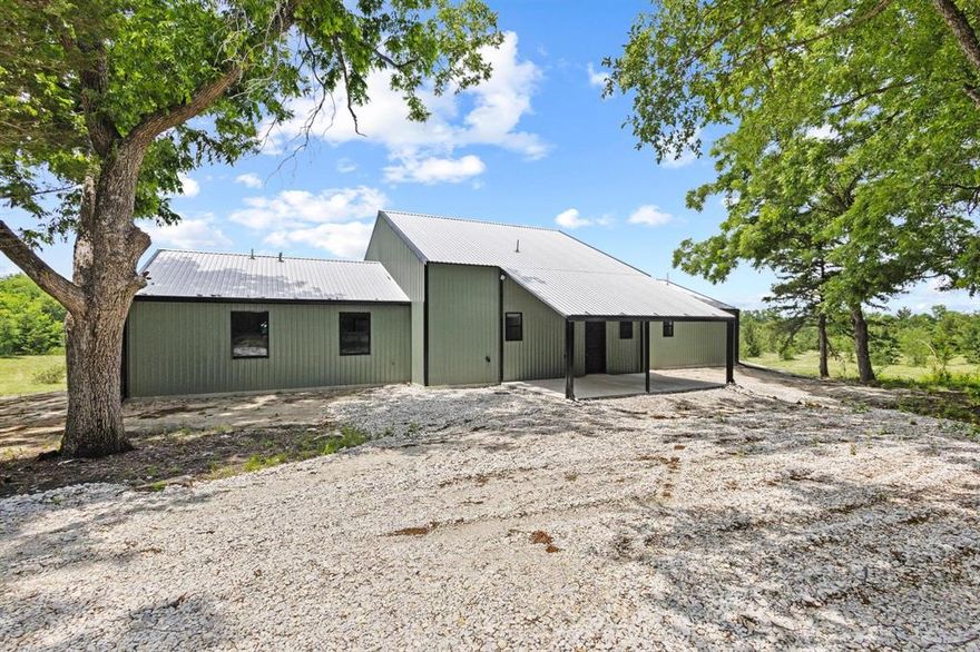 Beautiful New Construction Barndominium  on 9.2 acres located in SW Lamar County Texas! Completed May on 2025, this home boast 3260 sq. ft of living, 4 bedrooms, 3 baths and a loft perfect for a game room, play space or man cave! From the moment you walk in, you will be blow away by the custom finish outs, vaulted ceilings and craftsmanship. Bead board and custom wood work throughout, high end finish outs, granite countertops, and beautiful epoxy floors. A large living dining combo ,  galley kitchen for entertaining, 3 bedrooms 3 baths down stairs and 1 bedroom and game room upstairs. Spray foam insulation, additional wiring for your future pool, blue tooth mirrors and so many other extras!. Outside, sit and relax on one of three covered porches ideal for relaxing and watching the countryside sunrise and sunsets. A small pond, mature trees and plenty of neighboring wildlife. Watch the deer and other small game roam. Just 1.30 hrs NE of DFW, take a trip to the country and enjoy as a new home or weekend place space!