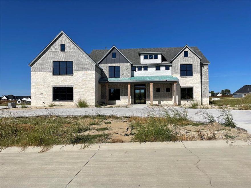 The Rushmore plan from the Cope Homes Luxury Series. This beautiful craftsman style home is located in the newest 1+ acre lot community in Van Alstyne, Capitol Hill. This home features a large open floorplan, two story ceilings, and an oversized 4 car garage. The kitchen features quartz countertops, Bar with Beverage Fridge, Kitchen Aid double ovens, gas cooktop, dishwasher and two large kitchen islands. First floor primary bedroom is oversized and features a seating area. The ensuite bath has a free-standing tub and dual shower heads in the walk-in shower. Other features include an office and large laundry room. The second floor has three bedrooms, two and a half baths, a game room with wet bar, and separate media room.  A large multi-slide glass door opens to the covered patio with a wood burning fireplace. NO HOA! Add your own shop, apartment, storage on the 1+ acre lot! If this isn't your floorplan, we have several other homes currently under construction in Capitol Hill!