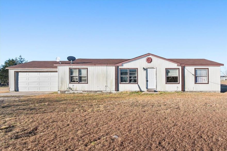 Bring your vision and creativity to this 4-bedroom, 2-bath mobile home situated just under an acre in Corsicana ISD, offering a true country-living feel with room to make it your own. This property is in need of some TLC, making it an excellent opportunity for investors, renovators, or buyers ready for a project.

Inside, the spacious living area flows seamlessly into the dining and kitchen spaces, creating an open layout ideal for gatherings once updated. The primary suite features an ensuite bathroom with a separate shower and garden tub, offering a great foundation for a future retreat. Three additional bedrooms provide flexibility for guests, home office space, or family needs.

A 2-car garage adds valuable storage and parking, while the generous lot offers space to enjoy the outdoors and rural surroundings. With the right touch, this property has the potential to be transformed into a comfortable country home.