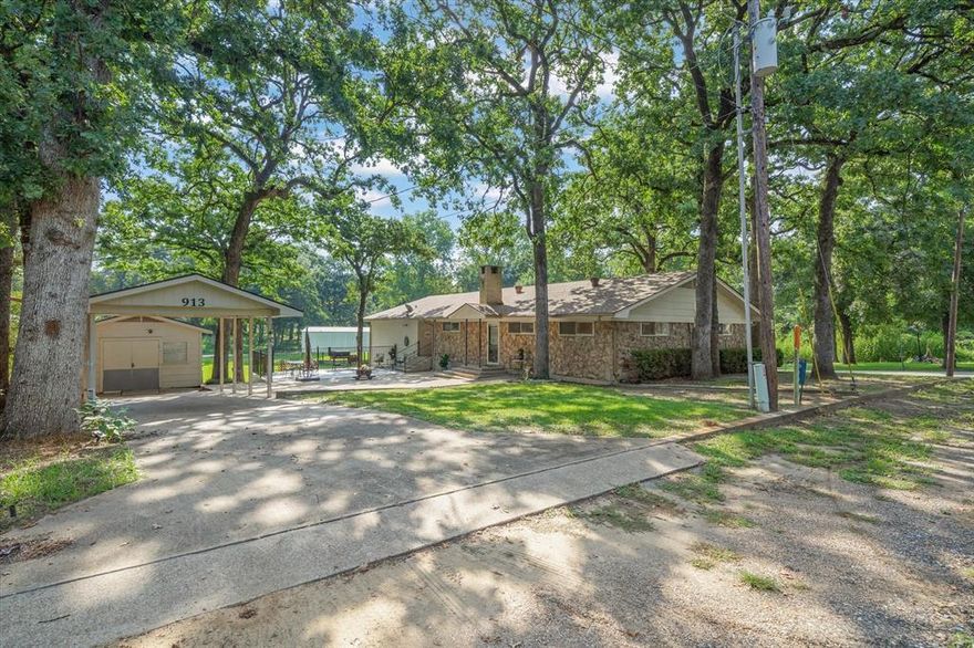 Buyer financing fell through! This one is back on the market and ready for YOU!!! PARTY ON THE PATIO!!! The star of this home is the expansive outdoor patio and green space — made for entertaining, family gatherings, and unwinding after a day on Cedar Creek Lake. FIRE UP THE GRILL, POUR A COLD ONE, AND LET’S GET THIS PARTY STARTED!
The home is designed with fun in mind, inside and out. You’ll love the open living and dining areas, large kitchen, and cozy brick fireplace. There’s room for all your toys too — covered storage for your boat, RV, and jet skis. Plus, the community pier and boat launch are just down the street. Drop a line, take a swim, or shove off for a day on the water. Set in a beautiful, treed neighborhood, this property offers the lake lifestyle without the waterfront price tag. Perfect as a weekend getaway, full-time home, or short-term rental.