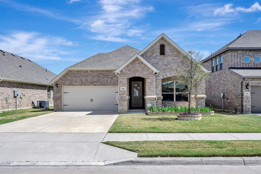 This stunning home offers views of pasture with Longhorn cows and Ft Worth skyline in the distance await you with the peace of the country yet close to shopping and entertainment for your convenience. Enjoy outside to a covered porch with a ceiling fan and enjoy the serene backyard that backs to a grazing pasture, providing peaceful views and plenty of privacy. Nestled in the master planned Live Oak Creek community, it is within walking distance to the neighborhood pool and park, ideal for family fun and leisurely afternoons. The spacious open floor plan features a large kitchen island, walk-in pantry, granite countertops, stainless steel appliances, a stainless farm sink, and a striking bronze faucet. The living area centers around a brick wood-burning fireplace while the wood-look ceramic tile adds beauty and easy maintenance throughout. The expansive primary suite includes a window seat, double-door entry to the ensuite bathroom, dual vanities, separate shower, garden tub, and a generous walk-in closet with built-in shelves.  Schedule a tour today to see everything this exceptional home has for you.