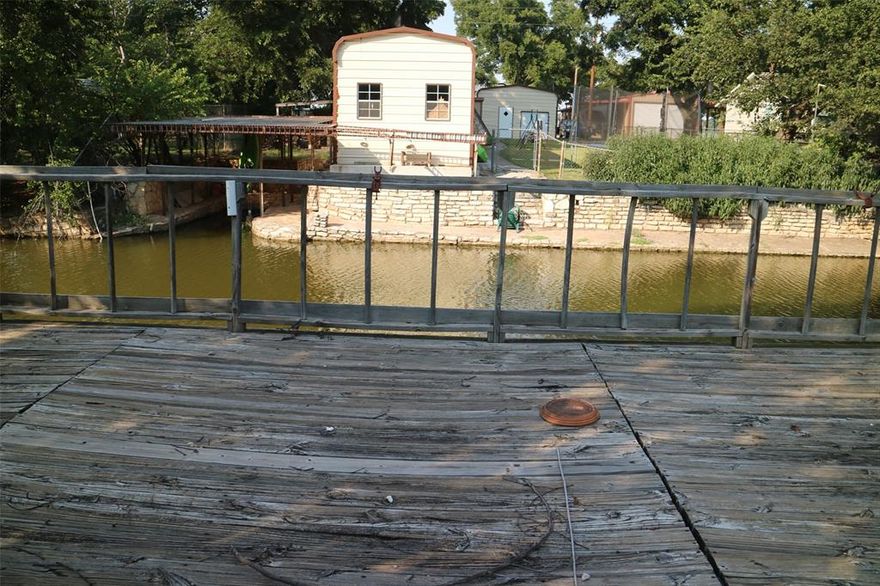 Welcome to your waterfront getaway! This unique property sits on a canal in Oak Trail Shores, offering direct water access. The main home is full of potential and ready for your personal touch. Outside, the property shines with a separate building that can serve as a shop, storage, or hobby space - perfect for projects and extra storage. You'll love the rustic fishing shack, a great spot to relax and cast a line right from your backyard. Whether you're searching for a weekend retreat, an investment, or a home you can update to fit your style, this canal-side property offers the perfect opportunity to enjoy lake living.