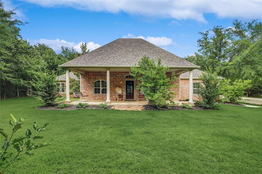 Charming 1-story home nestled on a sprawling 2.5-acre property adorned with majestic trees including some apple, peach and pear, offering a serene and private retreat and just a short trip down the street to the shores of Lake Ray Roberts. Step inside to discover the timeless beauty and an open plan with wood floors that flow throughout much of the home. The kitchen boasts elegant granite counters and gleaming stainless steel appliances, creating a chef&#39;s paradise. With roomy split bedrooms, privacy is ensured. The oversized garage provides ample space for parking and storage. Unwind in the generous family room, perfect for hosting gatherings and creating lasting memories. The master suite is a tranquil oasis, complete with a garden tub, shower, and a generously sized walk-in closet. Outdoor living is a delight with a large covered patio, ideal for relaxing &amp; entertaining, as well as a covered porch to savor the peaceful surroundings. Covered RV parking, a greenhouse and so much more!