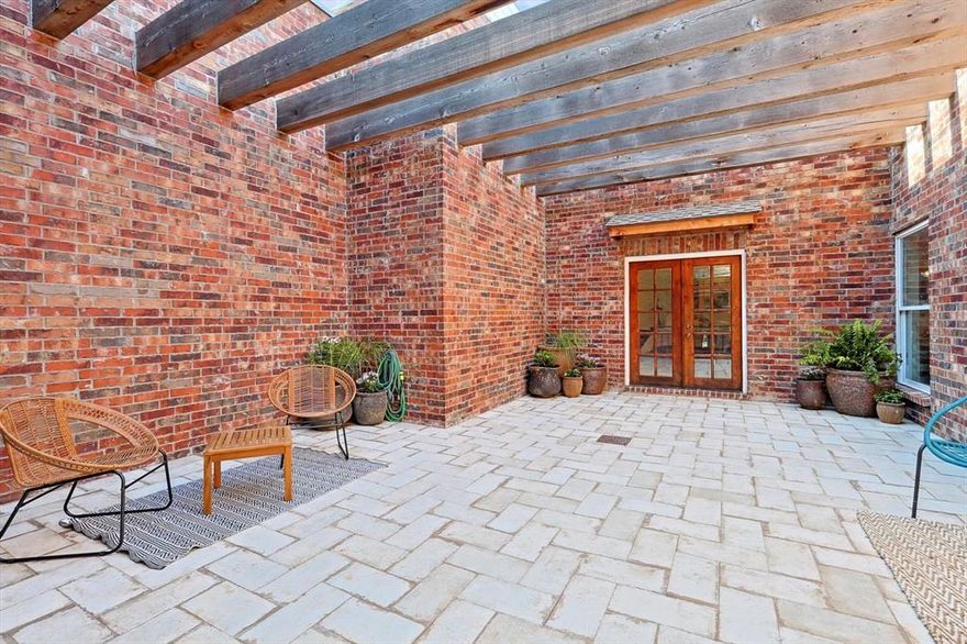 Discover your lakeside sanctuary on nearly a full acre surrounded by towering mature trees. This secluded gem offers serenity and natural beauty mere steps from the lake, scenic trails, and excellent shopping and dining options. Take leisurely walks or golf cart rides to Lakeside for magical horse carriage and sleigh rides during holidays, Friday evening outdoor concerts in summer, or cozy bonfire gatherings in fall. The expansive primary suite boasts private sitting areas, dual bathrooms and separate closets. Whether enjoying quiet solitude in the private courtyard or relaxing evenings in one of 2 living areas, this home emanates warmth and character. Perfect for creators, the property features an air-conditioned workshop with storage, plumbing, and electricity, plus adjacent studio space ideal for hobbies or home office use. Premium touches include granite kitchen countertops, charming pocket doors, exposed brick accents, and hardwood with Italian porcelain flooring. Listed square footage excludes the additional 282sqft and 200sqft studio spaces, making this truly exceptional