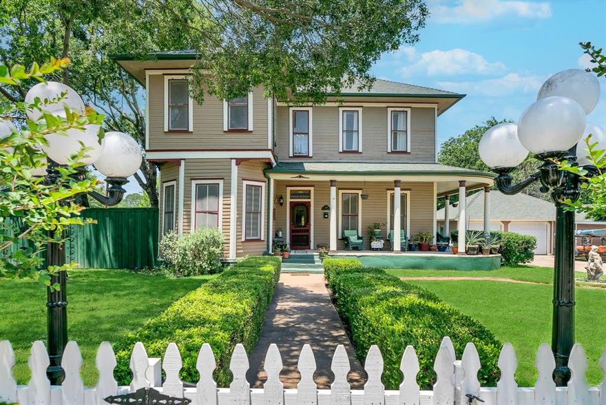 Charming Victorian Painted Lady built in 1896, the Jackley Home sits on a corner lot in the historic district. Only 1 block from Cherry Park, a few blocks from Chandor Gardens, and walking distance to the town square and courthouse with local food and shopping.  Historical charm of gingerbread trim, 12ft high ceilings, some original light fixtures & 2 clawfoot tubs meet with modern amenities, such as 2 central AC units (2021, 1 up & 1 down), whole house water filtration, & whole house Generac generator.  2025 updates include new kitchen floors, dishwasher, paint & more!  Rare in this era of home, all bedrooms even have a closet!  2 car garage with workshop & electric, attached shed, and oversized concrete driveway for babying your cars, boat, etc.  Rooms inside are spacious and multifunctional.  Enjoy a great view of Heritage Park fireworks on your wraparound porch, surrounded by Tiff Tuff grass, Pecan, Oak & Redbud trees, enclosed by a new white picket fence and charming outdoor lights. The side and back yards are enclosed with a new 8' privacy fence.  Original 1800's survey & title abstracts of more than 100 yrs.  Many updates done on foundation, plumbing, etc.  Custom fitted Christmas lights new in 2024.   Mineral rights available!