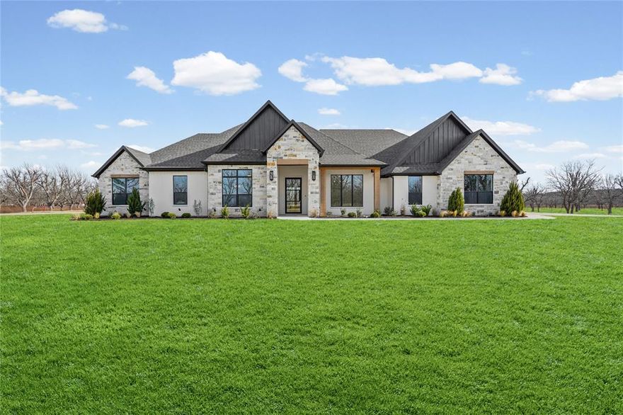 Experience refined living in this Modified Bodega Signature Series home, masterfully crafted by Couto Homes in the prestigious, gated community of Pecan Plantation in Granbury. This exceptional 4-bedroom, 3.5-bathroom home spans 3,527 square feet and offers a thoughtful layout featuring a private study, spacious game room, and 3-car garage. Step through the striking 8-foot iron front door into a stunning barrel ceiling entryway that leads to an inviting, open-concept living area anchored by a stone fireplace with a rich wood mantle. Expansive windows fill the home with natural light, enhancing the warm, elegant design throughout. The gourmet kitchen is a chef’s dream—complete with a large center island with dual sinks and breakfast bar, gas cooktop, double ovens, microwave, and abundant cabinetry for storage. A flexible game room provides additional space for entertaining, hobbies, or relaxation. Retreat to the luxurious primary suite, featuring dual vanities, a double walk-in shower, a freestanding soaking tub, and an impressive closet with room to spare. Enjoy peaceful mornings or lively evenings on the expansive front and back porches, each finished with stained beadboard ceilings, perfect for entertaining or soaking in the serene surroundings. Located within Pecan Plantation, residents enjoy 24-7 gated security and an unparalleled lifestyle with championship golf, multiple swimming pools, tennis and pickleball courts, fine dining, a car wash, and even a full-service grocery store—all inside the gates. This home perfectly blends luxury, comfort, and convenience—crafted with exceptional quality and situated in one of Granbury’s most sought-after communities. Don’t miss your chance to call this new Couto masterpiece home!