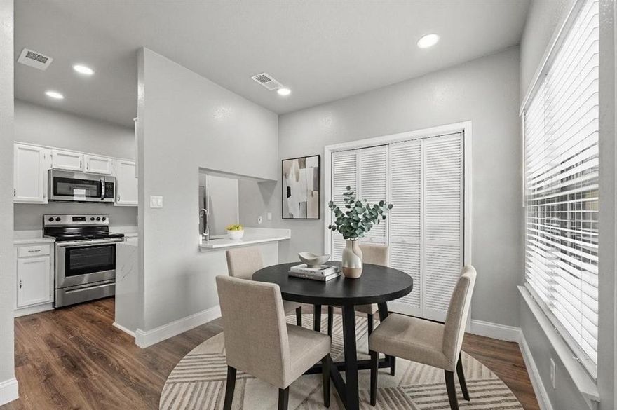 Experience the peak of modern North Dallas living in this stunningly renovated condo that radiates with natural light from morning until dusk. As you step inside, your eyes are immediately drawn upward to the soaring vaulted ceilings and skylights that create an airy, expansive atmosphere. The living room serves as a sophisticated retreat featuring a cozy brick fireplace and gorgeous new flooring that flows seamlessly into the dining area. The kitchen is a true showstopper for the home chef, boasting sleek white cabinets, stainless steel appliances, and a convenient pantry. Dramatic waterfall quartz countertops elevate the space, complemented by a breakfast bar designed for casual mornings or evening cocktails. Retreat to the spacious primary bedroom or enjoy the updated bathroom that reflects the same modern aesthetic found throughout the home. A private balcony offers a peaceful escape with a glimpse of the sparkling community pool. For ultimate convenience, the washer, dryer, and refrigerator are all included to make your move-in effortless. Rare for condo living, this unit includes a garage in the building with overhead storage for all your gear. Peace of mind comes standard with a recently replaced AC unit and new windows for maximum efficiency. Located in a secure gated complex with two pools and a grilling area, you are just one mile from the renowned Belt Line corridor. Enjoy instant access to the Dallas North Tollway, 635, and 75, putting the best shopping and dining in the city right at your doorstep. Take a first-person look at this gorgeous home! Click the Virtual Tour link to see the 3D Tour!