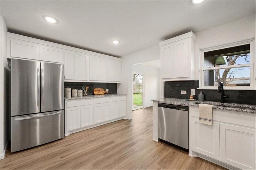 GREAT VALUE. WONDERFULLY UPDATED ENERGY EFFICIENT LIGHT BRIGHT AND OPEN 3 BEDROOM 2 BATH HOME IN DESIGNER NEUTRALS. To help minimize your electric bills, this  precious property has foam insulation throughout, including garage, an insulated garage door, a gas tankless water heater, and a gas range which should please the chef in the family. Kitchen has ample prep space with granite countertops, plenty of room for a rolling island, and opens to a large dining or breakfast room. The flooring is appealing luxury vinyl planking in all common and wet areas, with stylish carpet in bedrooms. Primary bedroom is ensuite and the bathroom has a large walk in shower. Conveniently located close to schools, restaurants, shopping, and major roadways. Buyer to verify square footage and schools.