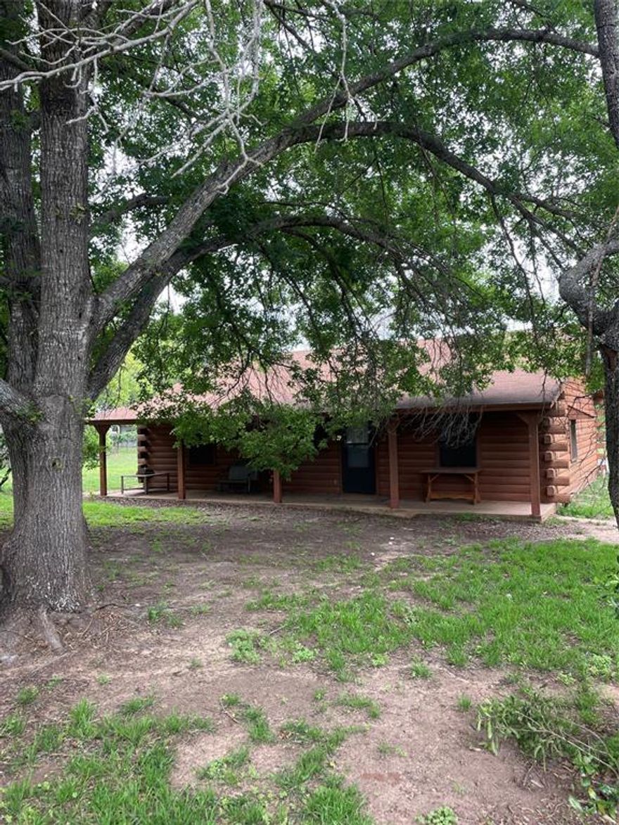 Log style home on just under 1 acre located in Clairette approximately 6 miles between Hico and Dublin.  Features include inviting front porch, abundant tree cover,  open floor plan, 2 beds and 1 bath.  Oversized auto garage contains climate controlled workshop with walk in storage closet.  Spacious utility garage is attached to but separate from auto garage.  Extra 12x24 building has been finished out and is climate controlled.  Grounds are fenced separately offering plentiful options. Refrigerator, washer, and dryer are included.