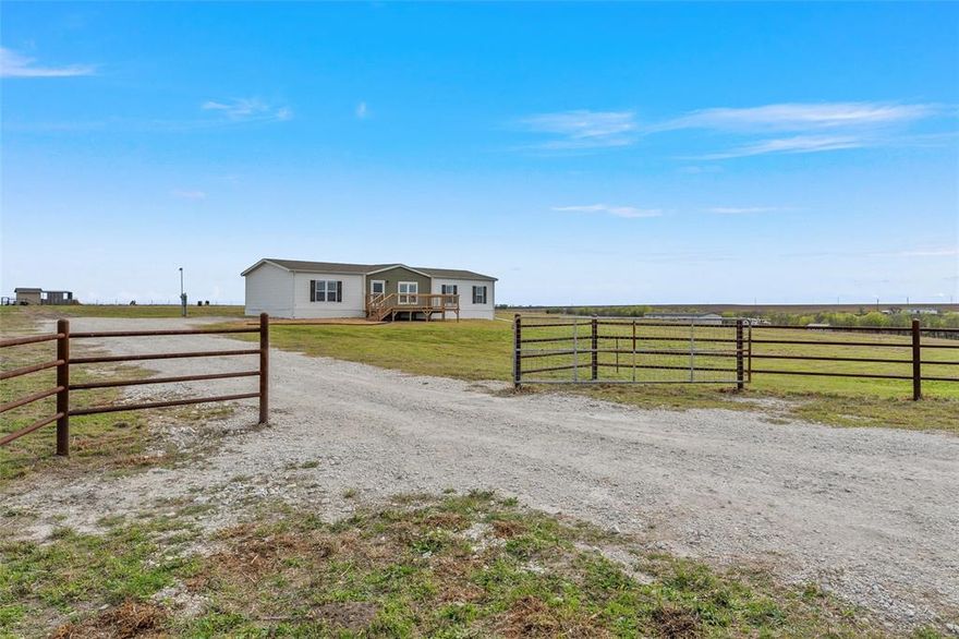 If you've been waiting for some land, this might be it! 20 acres, fully fenced, ready for horses, with a pond and room to breathe. This property is perfectly set up with an iron pipe entry fence, crossed fenced, corrals, two outbuildings. Also cross-fenced with two separate entrances, including a secondary access point from an adjacent tract. Power and water are available at the road, offering excellent flexibility if divided into two separate properties. Currently under ag exemption. The house is in immaculate shape with 3 beds, 2 baths, and two living areas. The best part? Stunning views of the conservation lake from the oversized front porch wood deck, living room, and primary suite. Priced below its recent $465K appraisal—step into an incredible opportunity to gain instant equity. Low taxes, little traffic, and total privacy—just the way country living should be.
