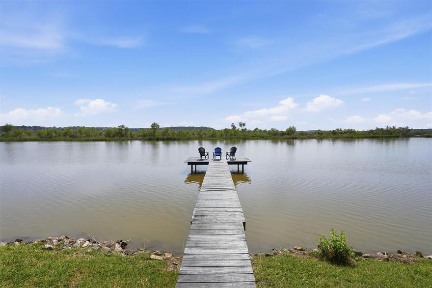 Waterfront living on Lake Granbury with space, shade, and unforgettable views...this one has it all.

Situated on nearly an acre, this beautiful 2,700 sq ft home offers 3 bedrooms and 2 baths with an open-concept layout designed for gathering, entertaining, and enjoying the lake lifestyle. The expansive living and dining areas flow seamlessly, creating the perfect setting for summer nights and time well spent with friends and family.

The upstairs primary suite is a private retreat—spacious and inviting, featuring a beautifully updated bathroom and a walkout balcony overlooking the water with spectacular views.

Step outside and experience what truly sets this property apart. This waterfront lot includes a private dock and is surrounded by mature trees—some nearing 200 years old—creating a breathtaking natural canopy. Multiple outdoor living spaces offer room to relax, entertain, or simply take in the peaceful setting.

This is more than a home… It’s a waterfront escape.
