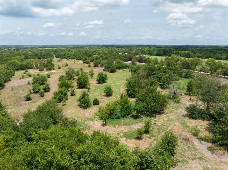 Tract 6 of 8 offers a beautiful 6-acre country retreat located less than five minutes from the historic town of Honey Grove, Texas, providing convenient access to local schools, grocery shopping, and restaurants. This property is just 9 miles from the new Bois d’Arc Lake, making it an excellent location for outdoor recreation and future growth. The land features mature trees that add natural beauty and privacy, creating a peaceful rural setting. Power is available, and a water line upgrade is currently in progress, adding to the property’s appeal and readiness for development. This tract is an ideal opportunity for those seeking a quiet country lifestyle with nearby town conveniences.