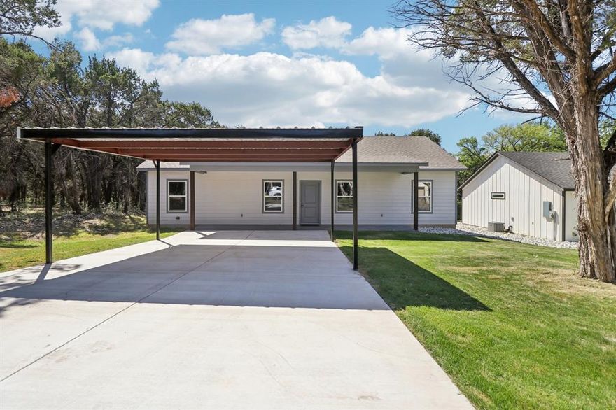 Beautiful and cozy brand new construction home completed in 2025 located in the sought after community of Fishermans Paradise in Rio Vista, Tx! Enjoy casting a line? Enjoy great fishing and quick access to Ham Creek and the Brazos River from your brand new home. Want to cook out and relax? Wander over to Ham Creek Park where you can launch the boat onto the Brazos River and the mouth of Ham Creek! This home and community offer a wonderful rural and laid back lifestyle. The home details: 3 bedroom, 2 bath, 1500 square feet, 2 car metal carport, and located on a very private cul de sac. Inside you will find a wide open floor plan with wonderful features. Large and open living room featuring vinyl wood flooring, ceiling fan, double pane vinyl windows, and high ceilings. Very functional kitchen with quartz countertops, super size kitchen island, ample cabinets, walk in pantry, and new appliances. Cooktop stove, dishwasher, and built in microwave. Breakfast area located just off the kitchen perfect for the family dinners. Separate full size utility room with washer and dryer connections and back door access to back yard. Large primary bedroom with a full size roomy walk in closet. Primary bathroom is to die for! Double sinks, exquisite garden soaking tub, separate oversized walk in shower, quartz countertops, and elegant cabinets. Bedrooms 2 and 3 are large and offer walk in closets with a convenient 2nd bathroom between bedrooms 2 and 3. How about the outside of this home! Sod, large mature trees, concrete front facing driveway, covered front porch AND covered back patio! Brand new aerobic septic system, coop water, coop electric, and a very private setting behind your home. A beautiful green area with a ton of trees giving you the ultimate in privacy. Top it off with a private setting near the end of a cul de sac! If your looking for a brand new home outside the City limits, not far from everything, low tax rate, and quick access to fishing and boating here it is!