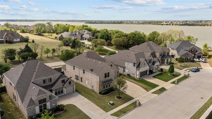 Located in the sought after Vineyards community with easy access to Lake Ray Hubbard, Lakeside Park, & Paddle Point Park, this beautifully designed PRE-INSPECTED 4 bedroom, 4.5 bath home with over 3,800 sq ft offers a perfect combination of space & functionality in one of Rowlett’s most desirable settings. Enjoy nearby walking paths, kayaking, fishing, volleyball, playground, community pool, & some of the most scenic sunsets in the area, all just moments from the property. Inside, soaring ceilings, striking spiral staircase, & a living room anchored by 20 foot ceilings create an open setting ideal for everyday living & entertaining. The versatile layout features a primary suite downstairs along with an additional bedroom on the main level, offering flexibility for multigenerational living or extended stays. A dedicated office or flex space provides a quiet workspace, while the spacious game room & media room deliver multiple areas for relaxation & recreation. One of the upstairs bedrooms includes its own private bathroom, offering the potential for a second primary suite or ideal guest retreat. The kitchen is well appointed & enhanced by a butler’s pantry, adding convenience & additional storage while seamlessly connecting the main living & dining areas. The primary suite offers a private retreat with ample space, a sitting area, & a well designed layout. Step outside to a custom covered back porch complete with a fireplace, creating a warm & inviting outdoor living space ideal for hosting, relaxing, or enjoying the peaceful setting year round. The home also features a 3 car garage & an oversized driveway. Thoughtfully selected upgrades were incorporated at the time of construction, adding to the overall quality & appeal of the home. Convenient access to Interstate 30 Texas, President George Bush Turnpike, & Texas State Highway 66, along with close proximity to grocery stores, shopping & dining, enhances the overall lifestyle & accessibility this location provides.