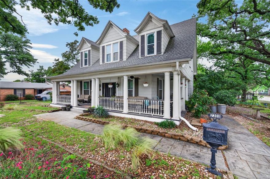 ~ Iconic wraparound porch
~ Half-acre corner setting
~ 3-car detached garage
~ Updated kitchen + baths
~ Original hardwoods throughout
~ Sunroom + flexible spaces!
Classic 1914 architecture meets thoughtful updates on a .5389-acre corner lot with standout curb appeal, mature trees & layered native landscaping. The wraparound porch creates an inviting entry & extended outdoor living space, setting the tone for interiors rich with character—tall ceilings, original hardwood floors & abundant natural light throughout. The main level offers two distinct living areas, including a spacious front living room with fireplace detail & a relaxed secondary living space with adjacent half bath, ideal for flexible use. Two first-floor bedrooms sit side by side, with one currently configured as an expansive custom closet that flows directly into a fully remodeled full bath. A large dining area connects seamlessly to the updated kitchen, featuring stainless steel appliances, pantry storage, open shelving accents & clean finishes. Updated electrical & double pane windows & no carpet help bring this beauty up to modern standards while preserving its historic integrity.
Upstairs, the layout expands with a bright sunroom lined with windows, creating an ideal bonus living or work space. Bedrooms are generously sized, each featuring double closets for ample storage & functionality. 2nd floor Bathrooms reflect updates with modern fixtures, a walk-in shower & separate tub. 
The fully fenced property with gated access offers privacy & usability across the expansive lot, while the detached 3-car garage provides exceptional parking & storage flexibility. Outdoor areas are thoughtfully designed for both entertaining & everyday enjoyment, with patio space, garden beds & established greenery. No HOA & convenient access to major highways complete the offering, delivering a rare combination of historic charm, usable land & modern updates in a highly accessible Fort Worth location.