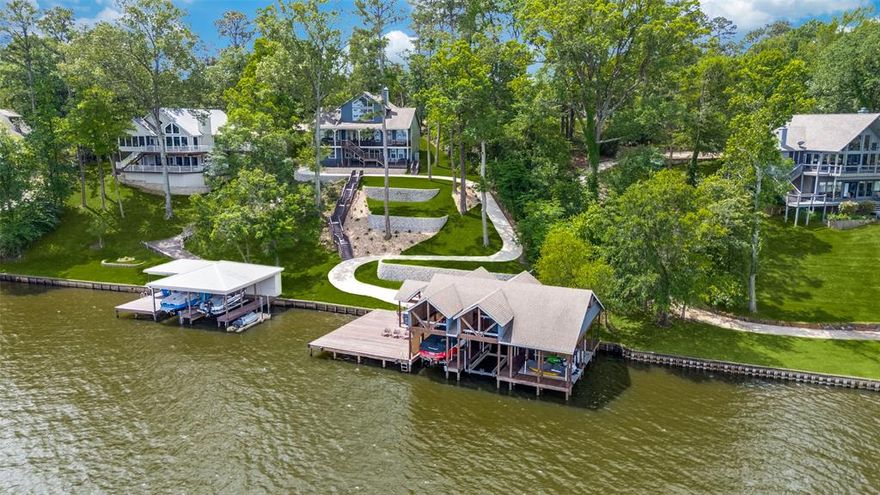 Perched on one of the most sought-after shorelines at Lake Cypress Springs this exceptional lake house captures panoramic, wide-open views of sparkling water from nearly every room and outdoor space. Recently refreshed with new landscaping, freshly painted interior & exterior, new decking, and a golf cart path, the property blends refined comfort with effortless lakefront living. Step inside to the main living area, where soaring vaulted ceilings, rich wood floors, and a striking wood-burning stone fireplace create a warm yet sophisticated setting. The open-concept kitchen is designed for both everyday living and entertaining, featuring a large island with seating, Viking appliances, double stainless refrigerator, gas range with vent-a-hood, microwave, dishwasher, and an oversized pantry—all seamlessly connected to the living space and lake views beyond. The main floor offers two generously sized en-suite bedrooms, along with a convenient laundry closet and powder bath. Upstairs, a spacious second living area with vaulted ceiling provides a stunning bird’s-eye perspective of the lake, complemented by a custom bunk wall, an additional en-suite bedroom, and a flexible bonus room ideal for overflow sleeping or a private office. Downstairs, the walk-out basement guest quarters deliver exceptional privacy with two bedrooms, each with attached baths, separated by a comfortable living area and kitchenette—perfect for hosting extended family and guests. Outdoor living takes center stage with multiple decks showcasing unforgettable sunset views and an incredible boathouse built for entertaining. Enjoy:Two boat slips, Four jet ski slips, Two storage closets Outdoor kitchen with granite countertops and double refrigeration space. Excellent water depth Additional features include fiber optic service extending to the boathouse, ideal for high-speed internet and security systems. Truly, Lake Life at its Finest!